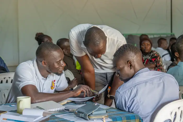 MSME owners working through business planning with advisors in Adjumani